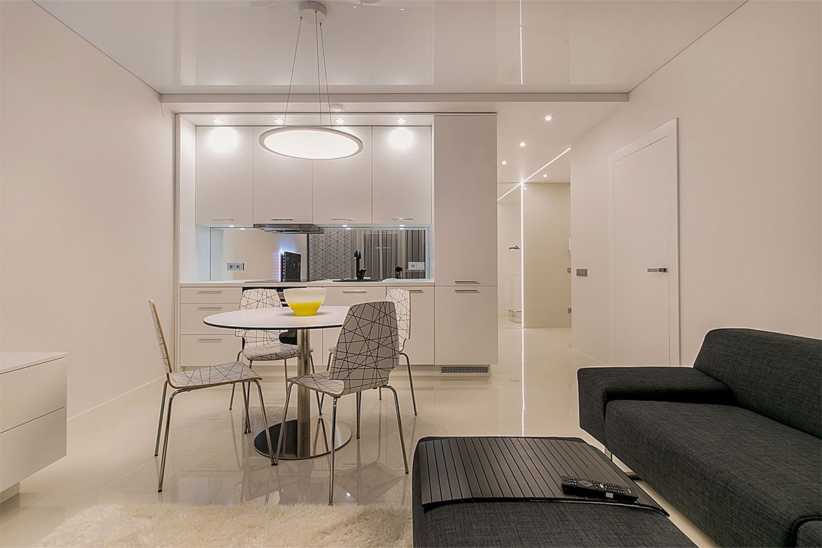 Recessed ceiling downlights illuminating a kitchen and hallway.