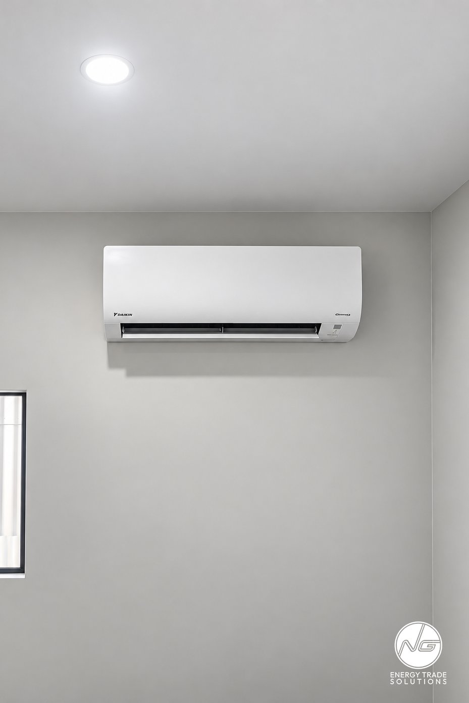 Daikin wall-mounted air conditioner installed on a grey interior wall.