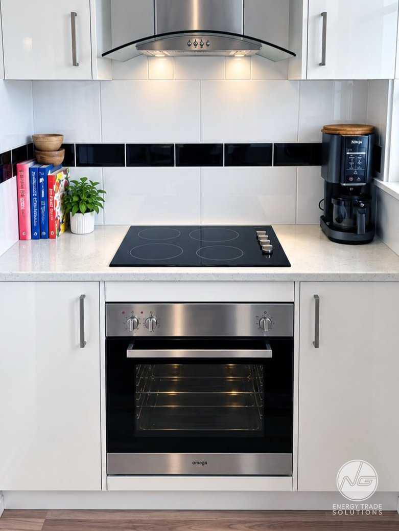 Electric cooktop, built-in oven and rangehood in a residential kitchen.