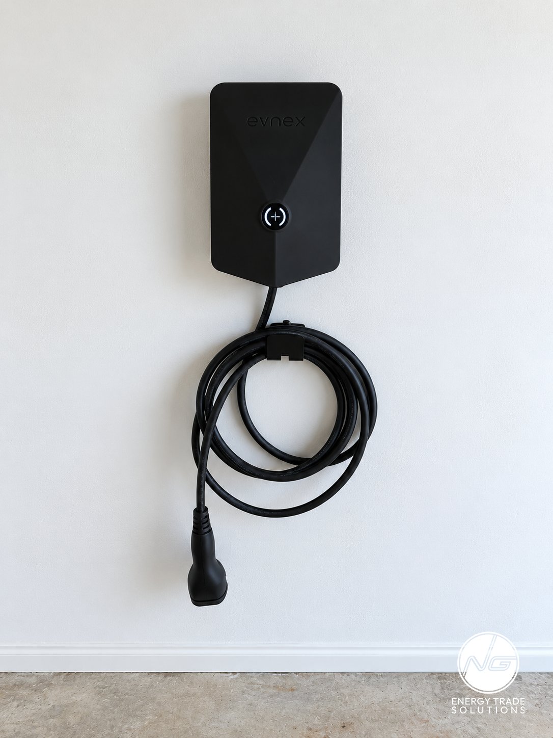 Black Evnex electric vehicle charger installed on a garage wall.