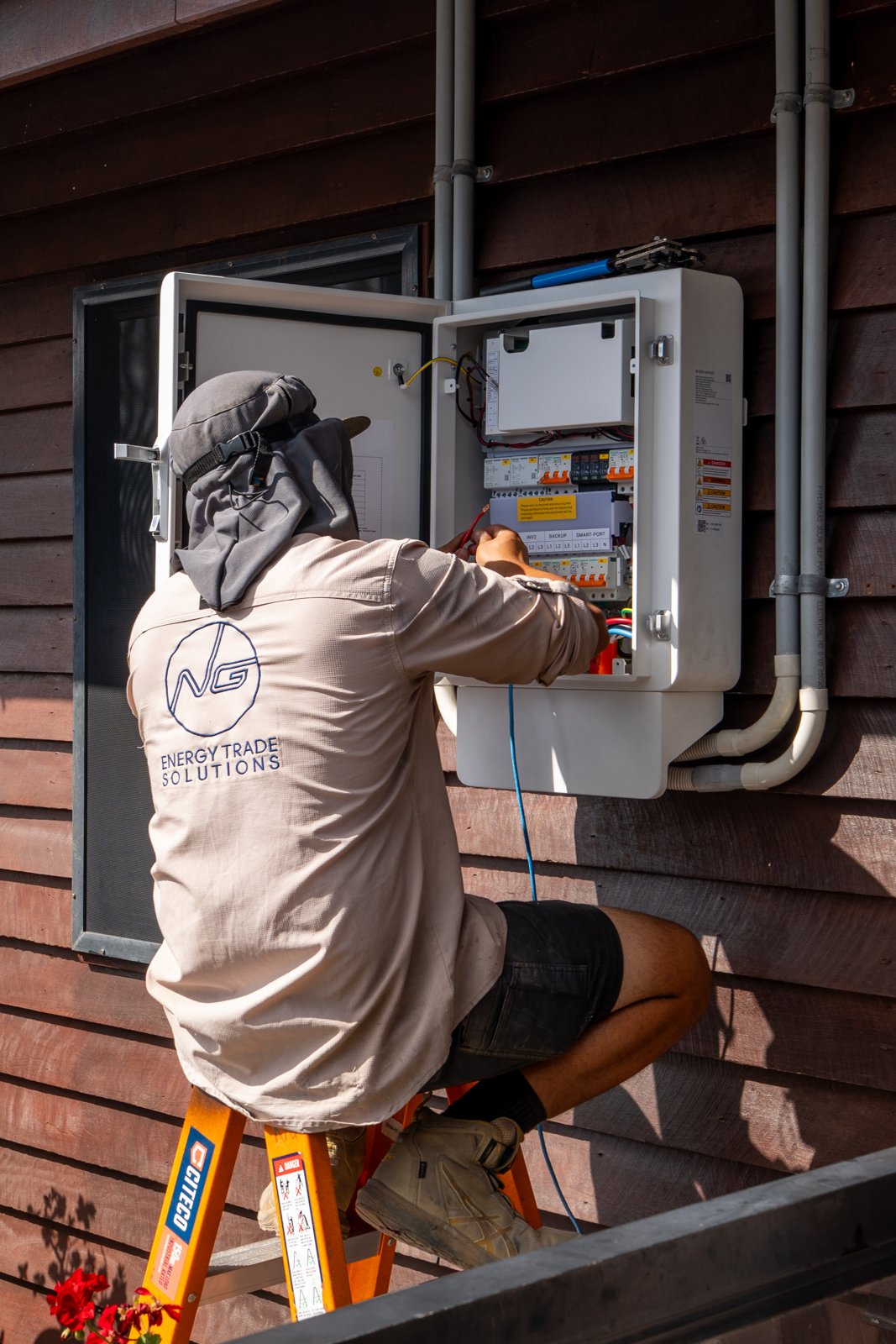 NG Trade Solutions technician working at an electrical switchboard.